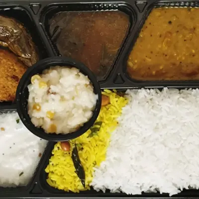 My festival meal platter is a customer favorite. This one includes a portion of sweet pongal, curd rice, pulihora, plain rice, dal, gutti vankaya, and a savory vada.