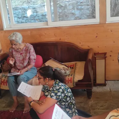 A moment of focused learning during our Himalayan retreat. Participants delve into the material, sharing insights in an intimate and supportive setting.