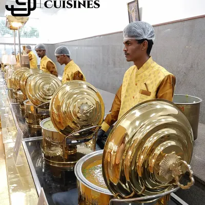 Our banquet staff are trained to manage high-end buffet setups with utmost professionalism. Pictured here are our servers in yellow vests, standing by a line of premium gold chafing dishes, ready to assist guests and ensure the buffet remains well-stocked and immaculate.