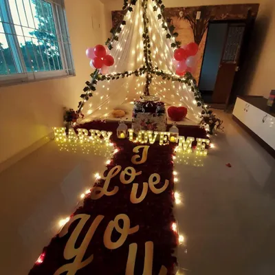 This is my signature romantic canopy setup, perfect for a proposal or anniversary. It features a "red carpet" of rose petals leading to a beautifully lit tent, with "I Love You" signs and marquee letters that say "Marry Me".