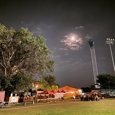 A serene night shot of our expansive grounds under a full moon. This image captures the calm and beautiful side of our venue, with the bungee tower visible in the distance.