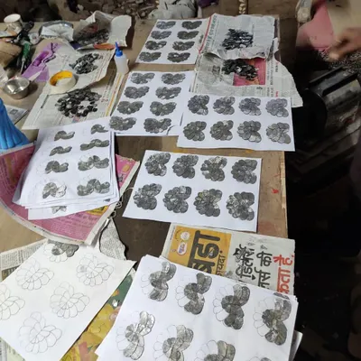 A work-in-progress shot of the Thikri glass panels, showing the individual components laid out on the design templates before being assembled.
