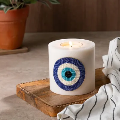 Ward off bad vibes with my evil eye candle. This large pillar candle features a beautiful, hand-beaded evil eye patch and can be used with a tea light, so you can cherish it forever.