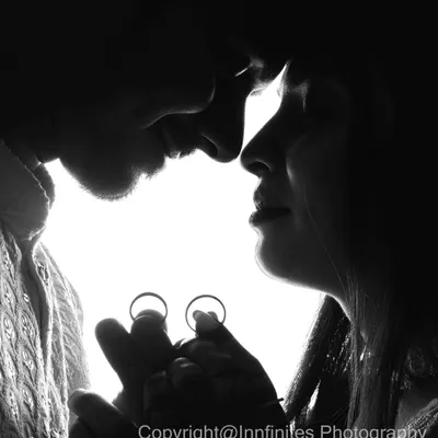 A creative black and white silhouette shot that beautifully incorporates the engagement rings, symbolizing the promise of a future together.