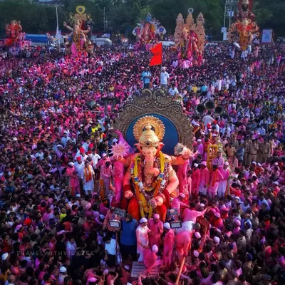The iconic Lalbaughcha Raja Visarjan, where the idol is surrounded by a sea of pink turbans and outstretched hands. This is the peak of devotion and energy that I strive to capture.