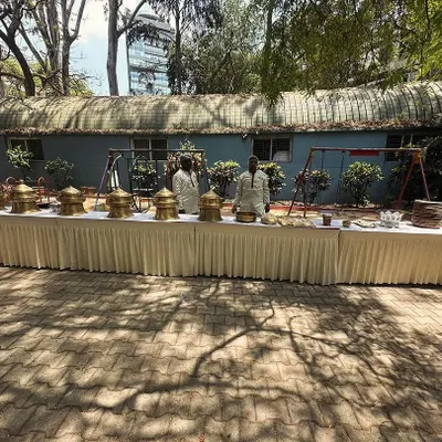 A full buffet setup for an outdoor event at Cubbon Park. Our elegant presentation includes traditional brass serving dishes to enhance the authentic dining experience.