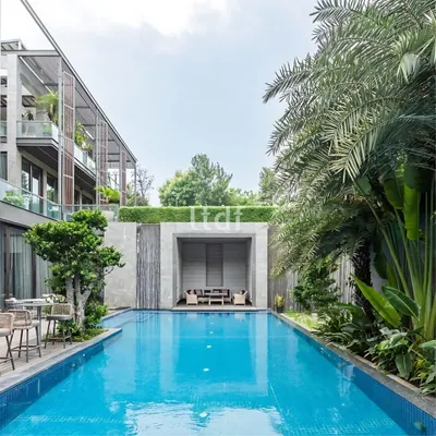 Villa Nova, a 30,000 sq. ft. luxury residence, showcases a striking architectural design that merges indoor and outdoor spaces. Its sleek exterior features expansive glass panels, filling interiors with natural light and offering beautiful views of the pool and surrounding landscape.
