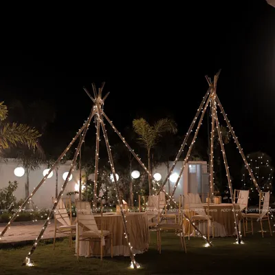 A magical outdoor dining experience. We created these enchanting teepee-style structures, wrapped in fairy lights, to provide a cozy and intimate setting for guests to dine under the stars.