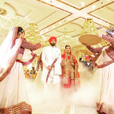 A spectacular entrance for the Sikh couple, complete with fog effects and traditional dancers. This is how you make a statement.