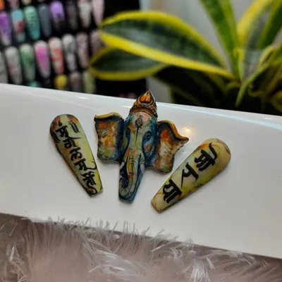 In celebration of Ganesh Chaturthi, we created this incredible 3D sculpted nail art of Lord Ganesha. The piece is accompanied by tips featuring hand-painted Sanskrit calligraphy, showcasing our deep respect for tradition and artistry.