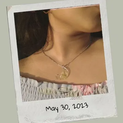 A model wearing my moon-shaped resin pendant with preserved baby's breath flowers. This shows how delicate and beautiful the necklaces look when worn.