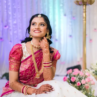 A beautiful South Indian bride, looking radiant in her traditional silk saree and temple jewelry.