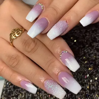 A stunning ombre effect fading from a soft lavender to white, with accent nails covered in sugar glitter and rhinestones at the cuticle.