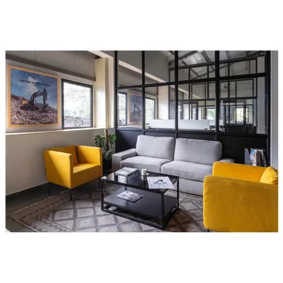 The waiting lounge in the Nagpur office facility. We used comfortable, modern furniture with pops of corporate color against a backdrop of glass and metal to create an inviting first impression.