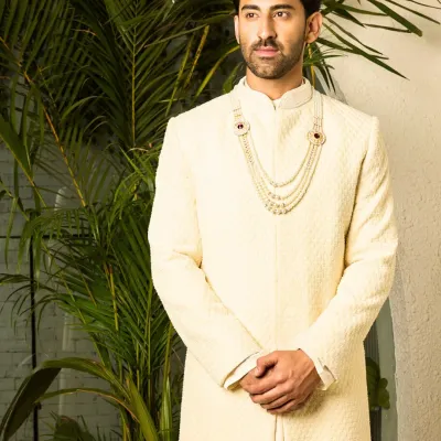 A full-length view of my classic off-white sherwani, tailored to perfection. The clean lines and premium, textured fabric offer a refined and regal look for the groom who values understated sophistication.