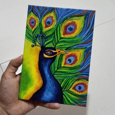 This acrylic painting of a peacock on a mini canvas captures the bird's magnificent colors. I used vibrant blues, greens, and yellows to make the feathers come alive.