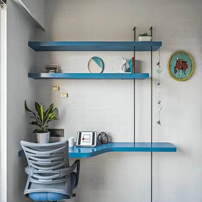 A minimalist floating study desk in a bright blue finish, with matching shelves above. This design is perfect for creating a stylish and functional work corner in a small space.