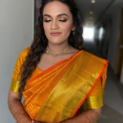 A close-up of the fresh, golden, glowing look on our beautiful bride in a Kanjivaram saree. The soft makeup and messy curls are a perfect match.