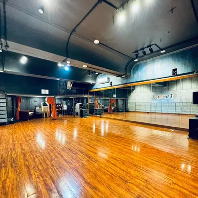 A wide view of our main dance hall. The space is designed to be open and versatile, perfect for choreographing large group numbers or intimate couple dances. The professional lighting and flooring help simulate a real stage environment during rehearsals.