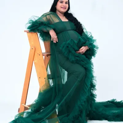 This stunning emerald green tulle gown is a favorite in my collection. The ruffled fabric creates incredible texture and drama, and the color is rich and vibrant. It's perfect for a glamorous and memorable portrait.