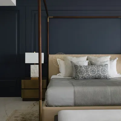 For this master bedroom in a South Bombay home, we created a moody and sophisticated sanctuary. A deep blue paneled wall serves as a dramatic backdrop for the four-poster bed, creating a perfect balance of drama and comfort.