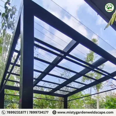 This completed pergola in Chikkagubbi features a 3mm compact sheet roof on a sturdy black metal frame. It provides shade and rain protection while maintaining a modern, open feel.
