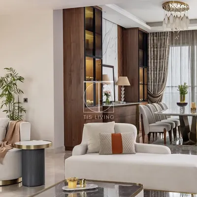 A complete living and dining space where we fabricated all the loose furniture. Notice the curved lines of the white sofa, the custom upholstery on the dining chairs, and the precisely crafted dining and storage units, all working together to create a cohesive, modern luxury environment.