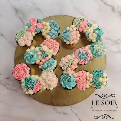 Why have a cake when you can have a cupcake cake? This is a pull-apart creation I made for a 25th birthday, arranging individual cupcakes into the number '25'. It's decorated with a mix of pastel buttercream florals and is perfect for sharing.
