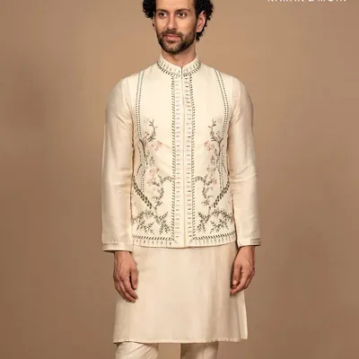 A full view of the ivory kurta set with its intricately embroidered Nehru jacket. The complete look is one of timeless minimalism, where every detail is intentional and every thread reflects purposeful design.