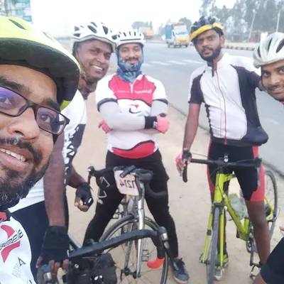 A selfie with the crew during a century ride. Everyone is geared up in full cycling kit, ready to take on the highway.