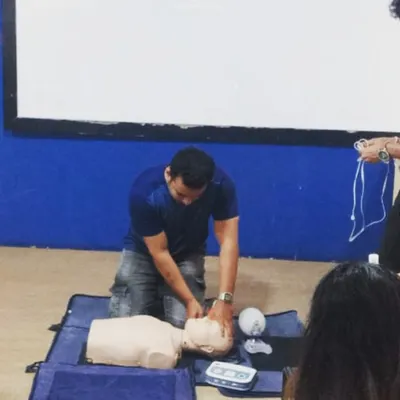 Here a team member practices chest compressions during our CPR certification course. We regularly update our skills to maintain the highest safety standards in the gym.