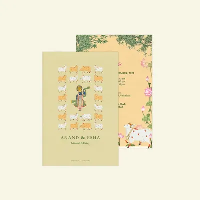 A custom invitation featuring beautiful traditional Indian graphics. The front card showcases an illustration of Krishna surrounded by cows, while the back card features the sacred Kamadhenu cow, both rendered in a classic Pichhwai style.