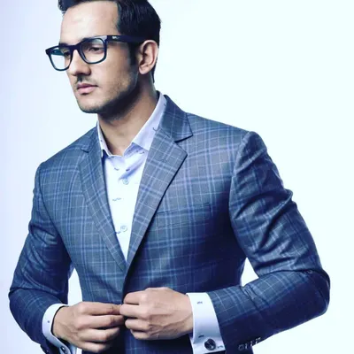 A modern blue plaid suit is a fantastic way to express personal style while remaining sharp and professional. I designed this piece with a slim fit and paired it with a custom shirt with French cuffs for an added touch of sophistication.