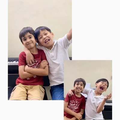 The pure joy of friendship and music! These two piano buddies, Avik and Daniel, share a laugh during their class, showing the fun, social atmosphere we cultivate.
