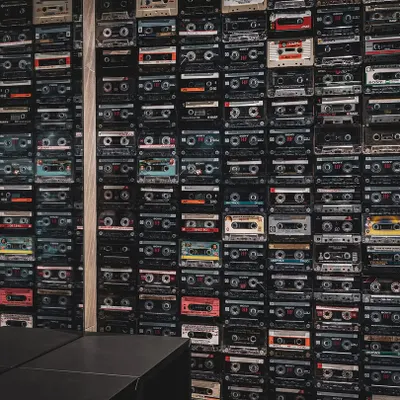 For the 'Chasing Tales' creative incubator, we designed this feature wall using hundreds of cassette tapes. This element of industrial design and nostalgia serves as a visual anchor in the coworking space, reflecting the project's goal of fostering creativity and community.