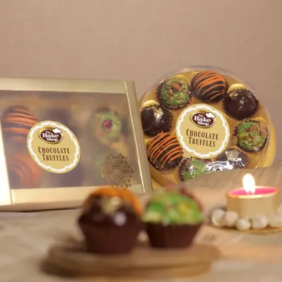 Our chocolate truffles are available in beautifully designed round and rectangular gift boxes. This image showcases our elegant packaging, making it an ideal gift for any celebration.