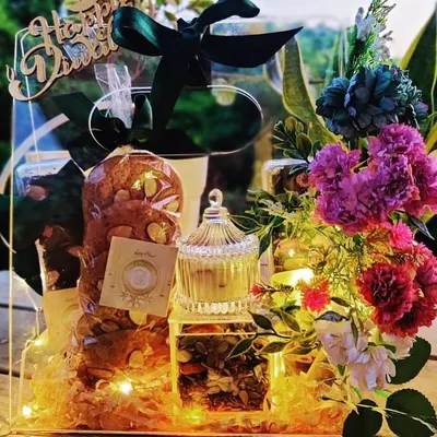 This Diwali, make your mark with our premium floral hamper. This acrylic box is filled with dry fruits, fairy lights, and beautiful flowers, creating a stunning presentation.