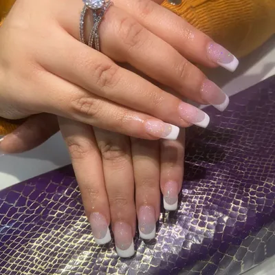 The perfect classic French manicure. This set features a soft pink base with crisp white tips on a medium-length square nail.