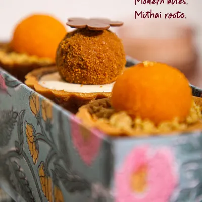 Modern bites with mithai roots. This close-up shows the beautiful texture and detail of our signature Mithai Tartlets, a fusion of Indian sweets and French pastry.