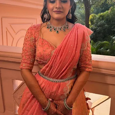Our client looking absolutely radiant in her custom-made peach langa davani, upcycled from a Kanchi saree. The perfect outfit for a wedding celebration.