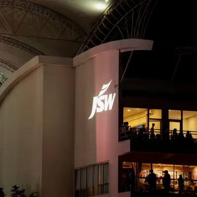 We turn the venue itself into a canvas for your brand. Here, a powerful projection of the JSW logo onto the stadium architecture creates a bold and unmissable statement, visible to all attendees upon arrival.