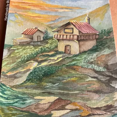 This watercolor painting is a composite of my memories from the mountains. It features cozy houses nestled on a green hillside against a warm, sunset sky. It’s a perfect example of the dreamlike "pahaad wale ghar" that I love to paint.