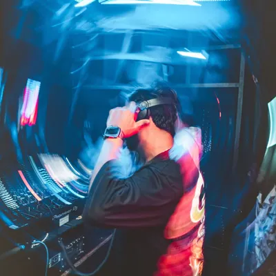 The energy transfer from the console to the crowd is everything. This shot from Club Illusion captures that moment of pure connection through music.