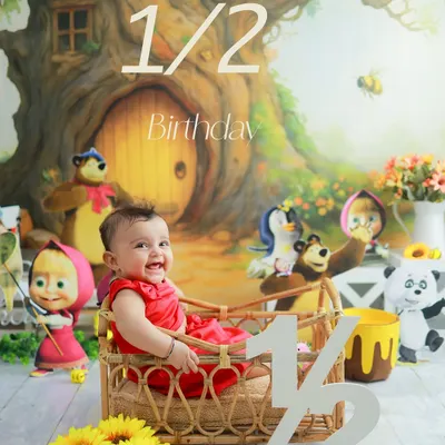 Celebrating six months of sweetness. This half-birthday shoot with a Masha and the Bear theme is full of joy and personality. The wicker basket and cartoon characters create a fun, storybook setting.