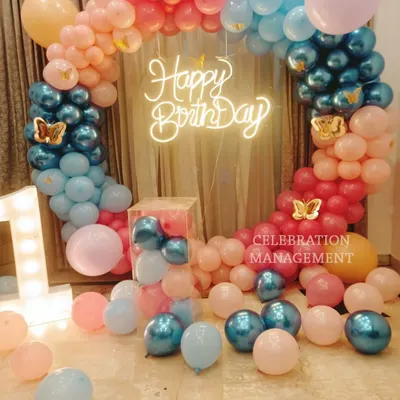 A magical butterfly-themed setup for a first birthday. I created a circular balloon arch in pastel pinks and blues with chrome accents, a 'Happy Birthday' neon sign, and a light-up number '1' to mark the very special milestone.