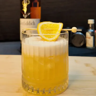 A classic Whisky Sour, perfectly balanced with a frothy top. This cocktail is a staple on my menu, made with your choice of whisky, fresh lemon juice, and a touch of sweetness.