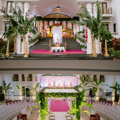 A tale of two views: the grand entrance of the wedding venue in Satara, and the stunning mandap setup waiting inside, ready for the ceremony.