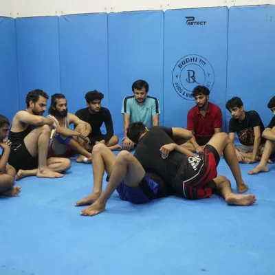 I am demonstrating a BJJ technique to an attentive class. This is where we share knowledge, and every student, from beginner to advanced, is focused on learning.