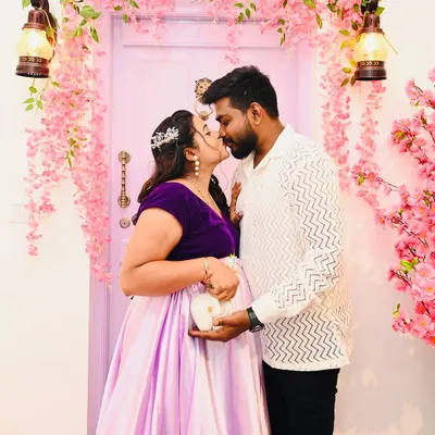 A classic pose in front of the blossom door, this shot highlights the joy of expecting. The couple holds baby shoes, a simple prop I provide to add a sweet touch to your maternity announcement.