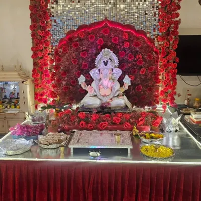 Here is the full view of our grand red rose and mirror sequin decoration. The setup includes a matching red table skirt and a wide stage, providing ample space for the idol and offerings, creating a powerful and cohesive look.